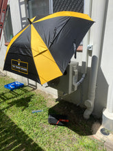 Load image into Gallery viewer, The Trade Shade - The Square Umbrella Shading An Air-Conditioner Demonstrating The UV Protection It Offers.