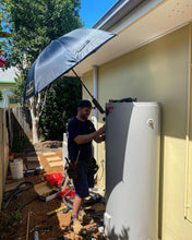 Load image into Gallery viewer, A Plumber Using The Trade Shade - Magnetic Umbrella Holder To Stay Protected From UV Rays While Working On A How Water System
