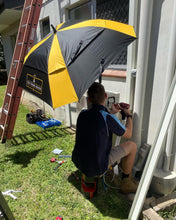 Load image into Gallery viewer, An Australian Tradie Working In The Shade Underneath The Trade Shade - The Square Umbrella.
